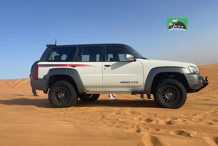a luxury nissan super safari standing at the desert with Desert Safari Duba